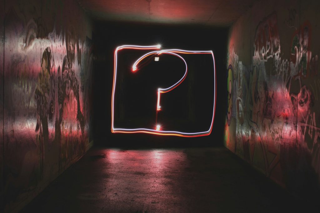 Glowing question mark light painting in tunnel